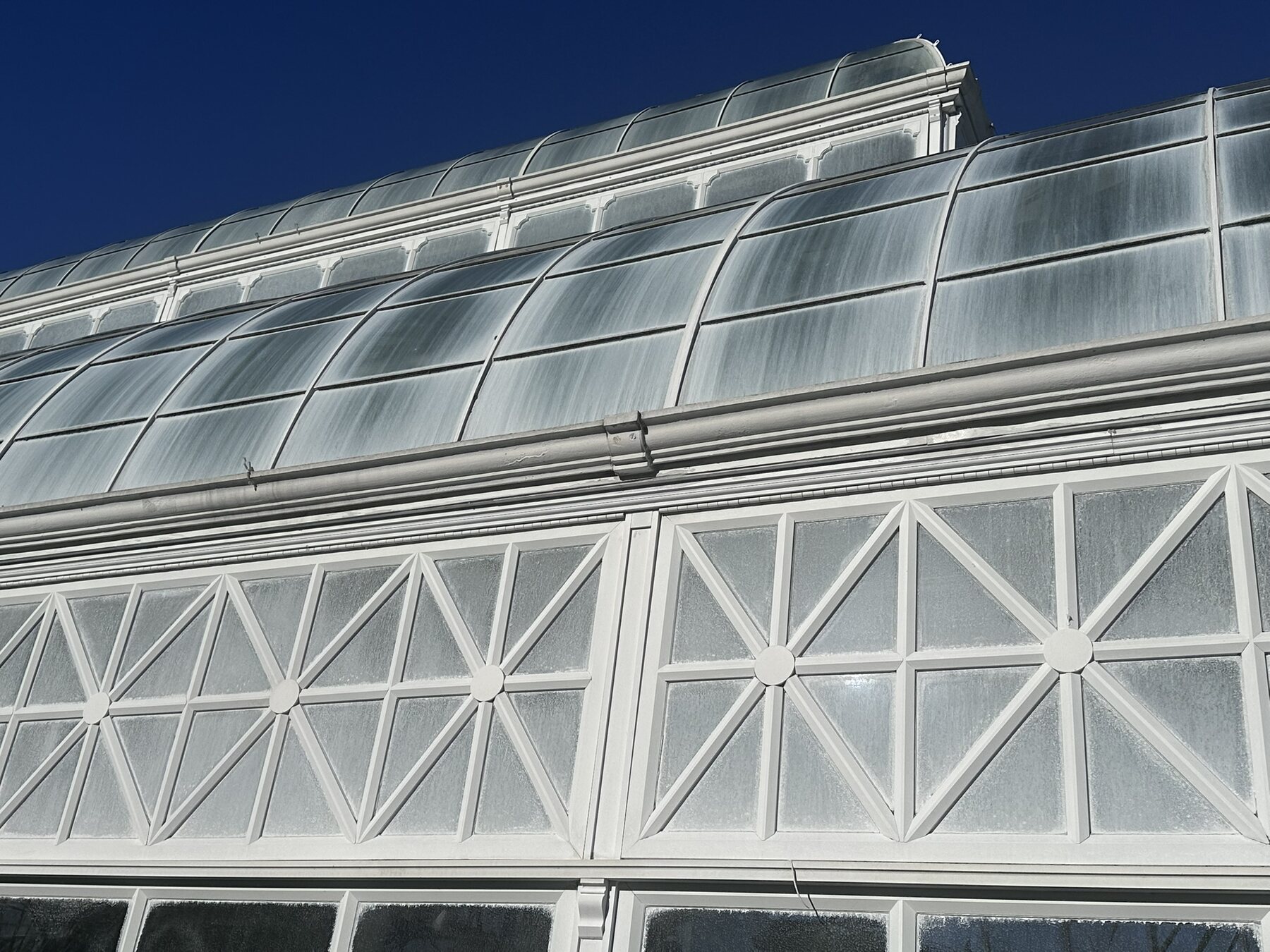 Frosted glass façade divided by dense white geometric framing